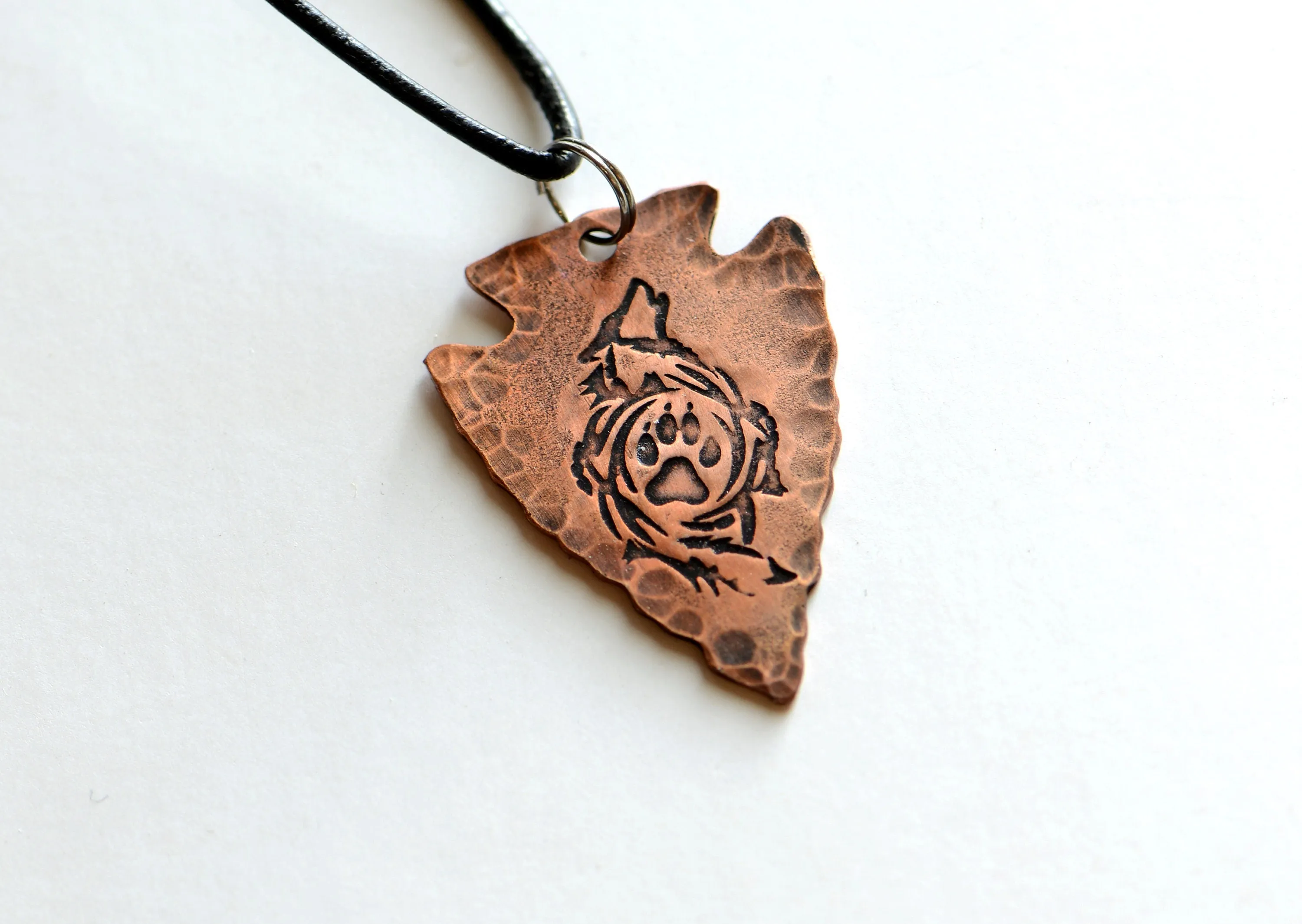 Arrowhead copper necklace  with howling wolf and paw