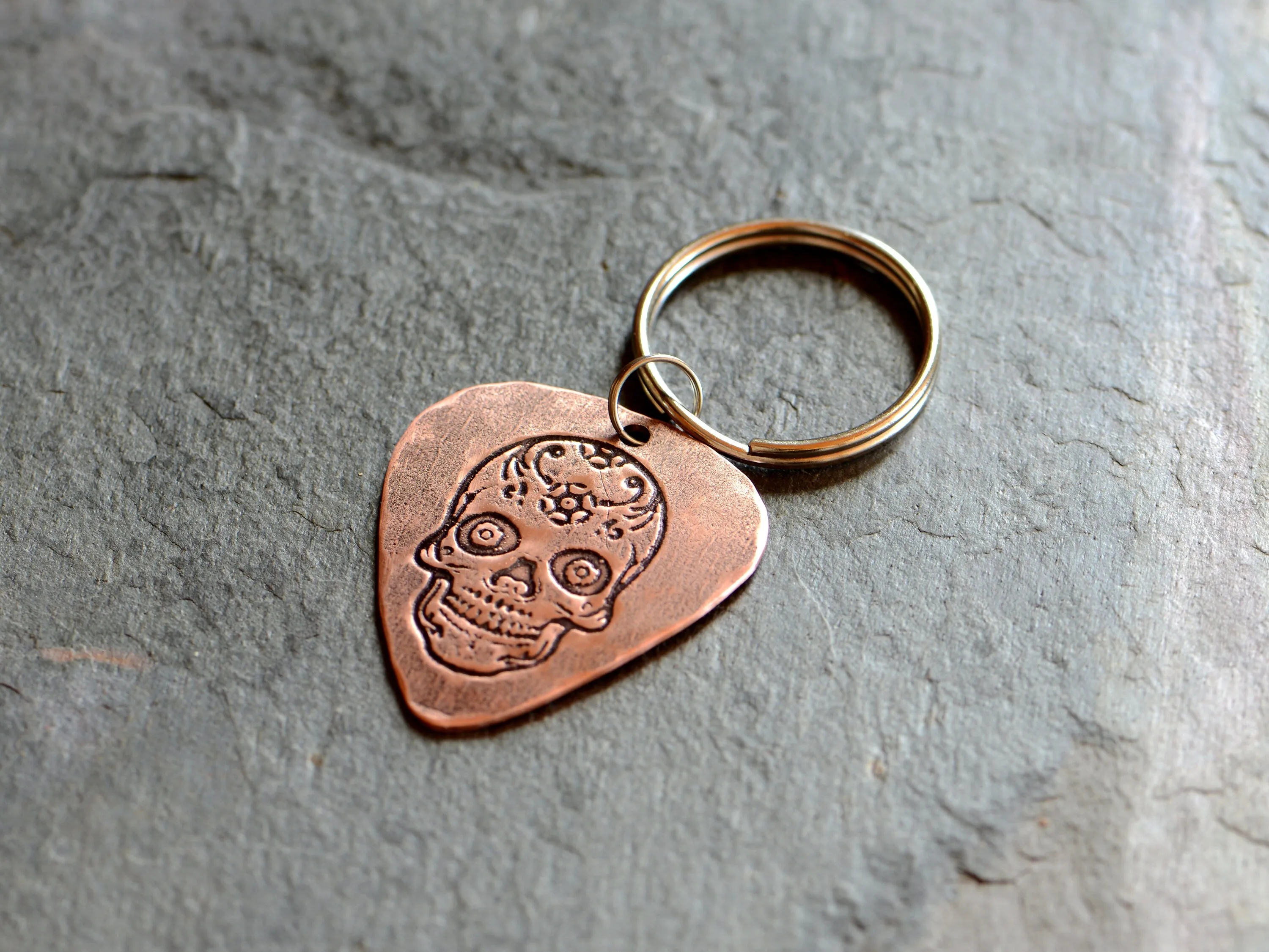 Copper guitar pick key chain with sugar skull