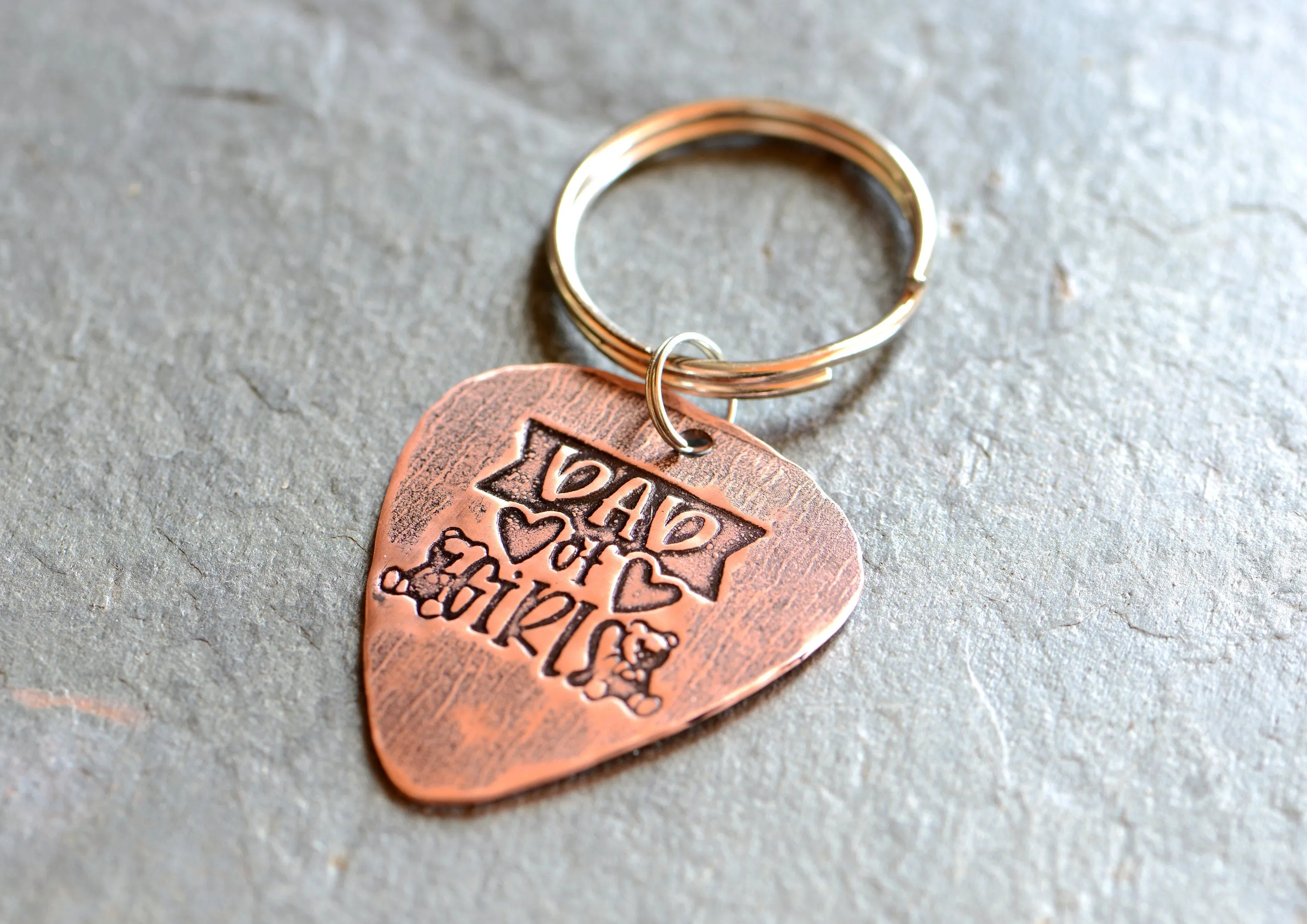 Copper guitar pick keychain stamped with dad of girls