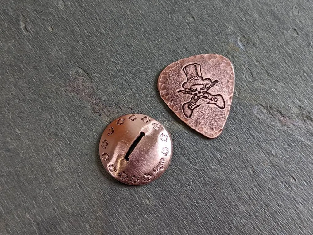 Copper guitar pick with skull and guitars theme