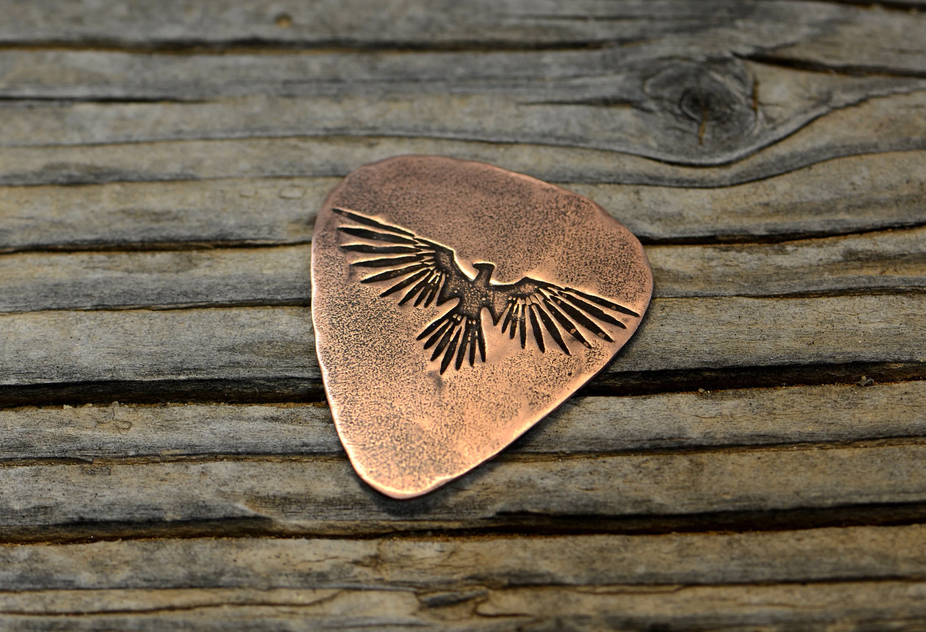 Copper guitar pick with Thunderbird