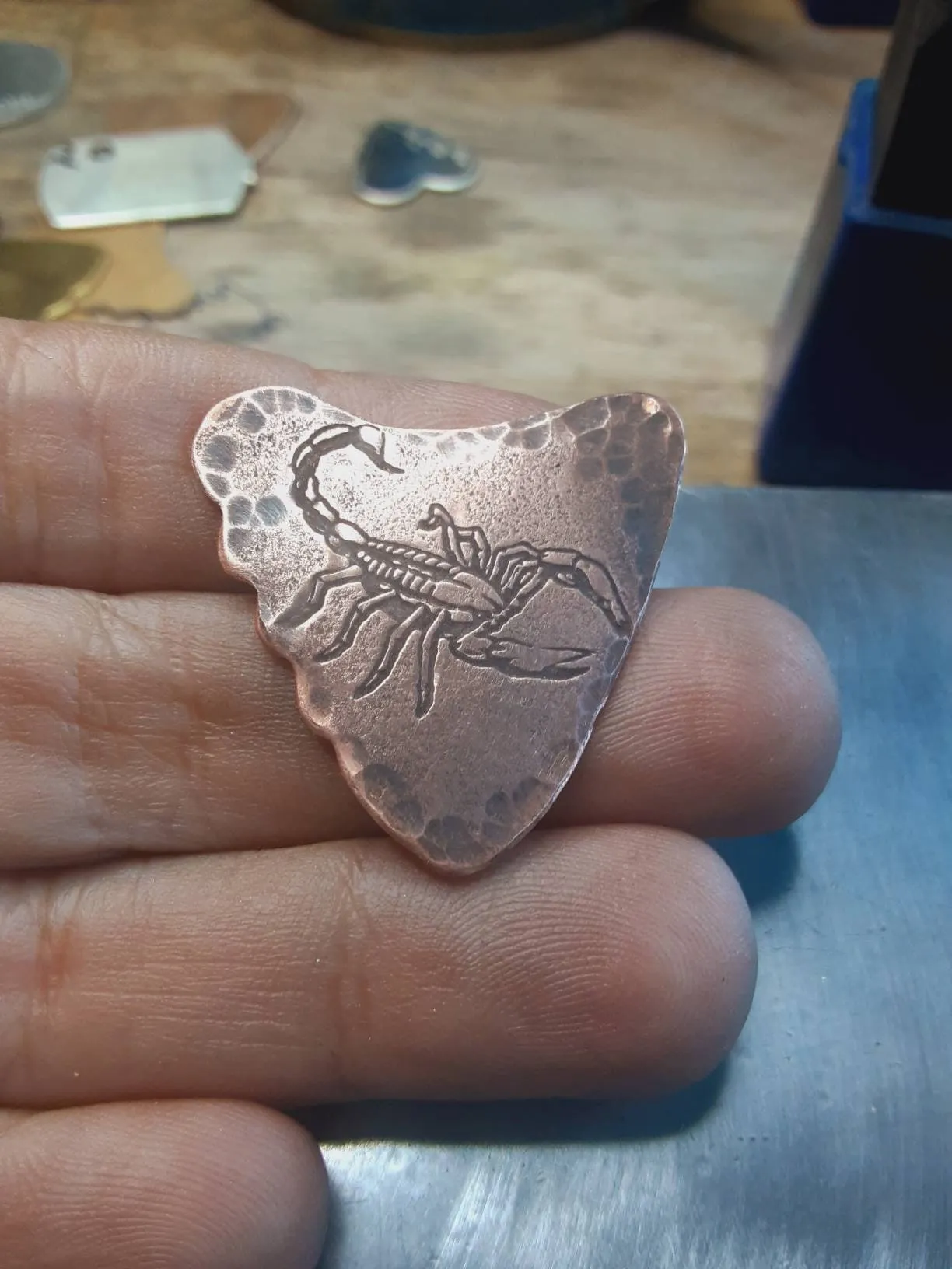 Copper shark tooth guitar pick with scorpion design