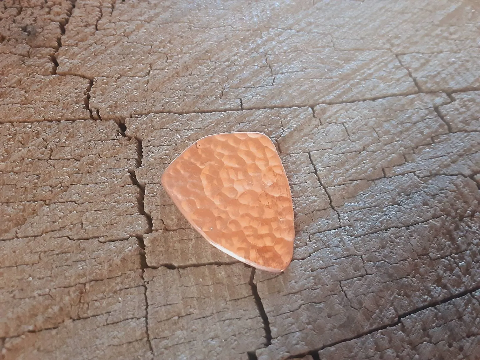 Copper shield shape guitar pick with music notes