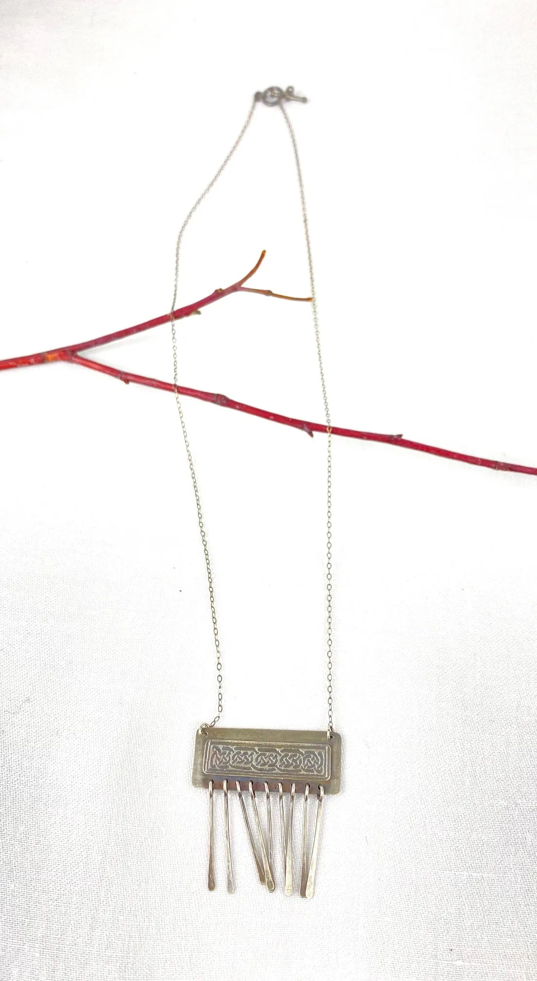 Etched Celtic design on silver necklace
