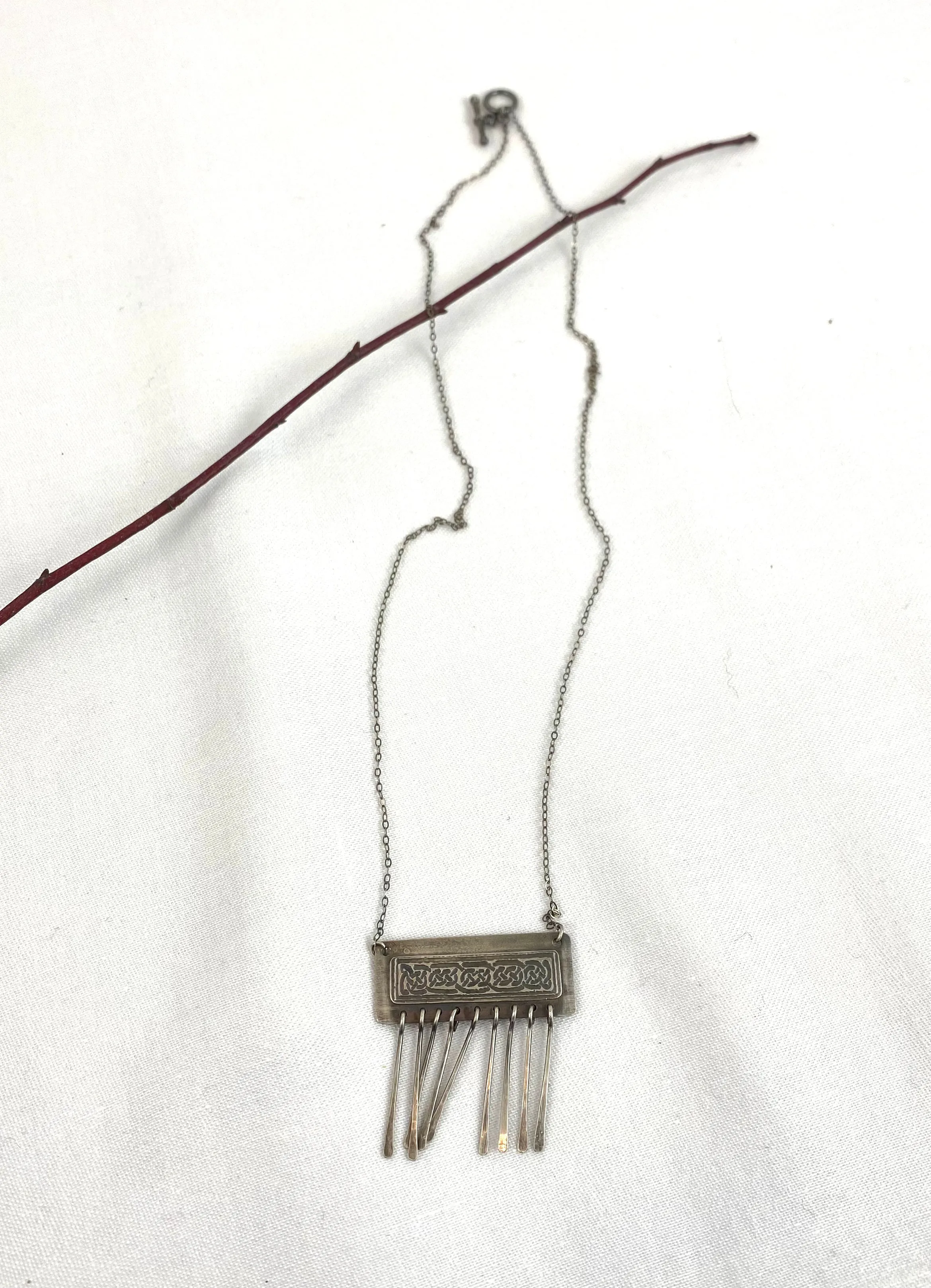 Etched Celtic design on silver necklace