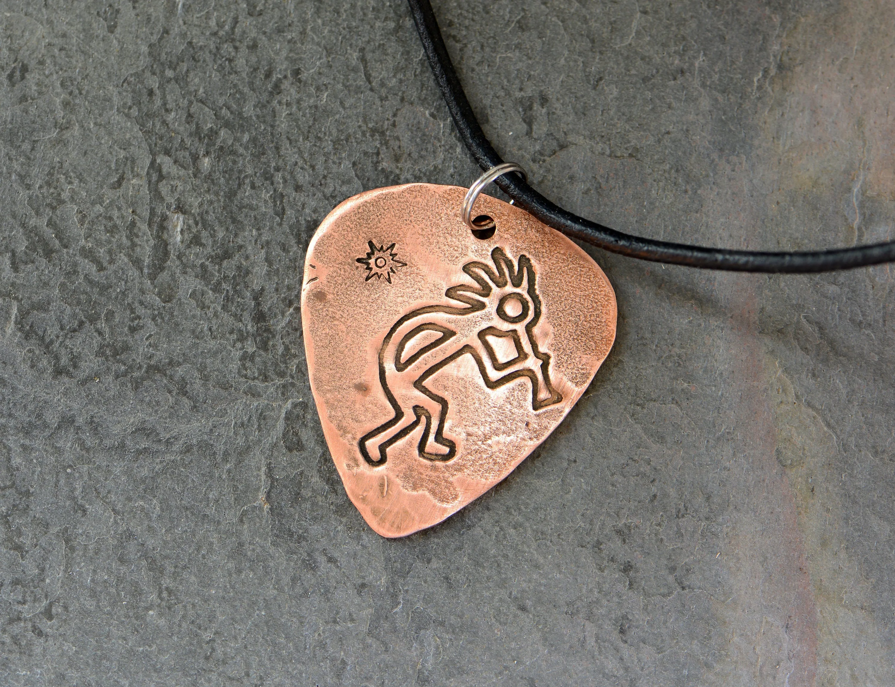 Kokopelli themed copper guitar pick necklace