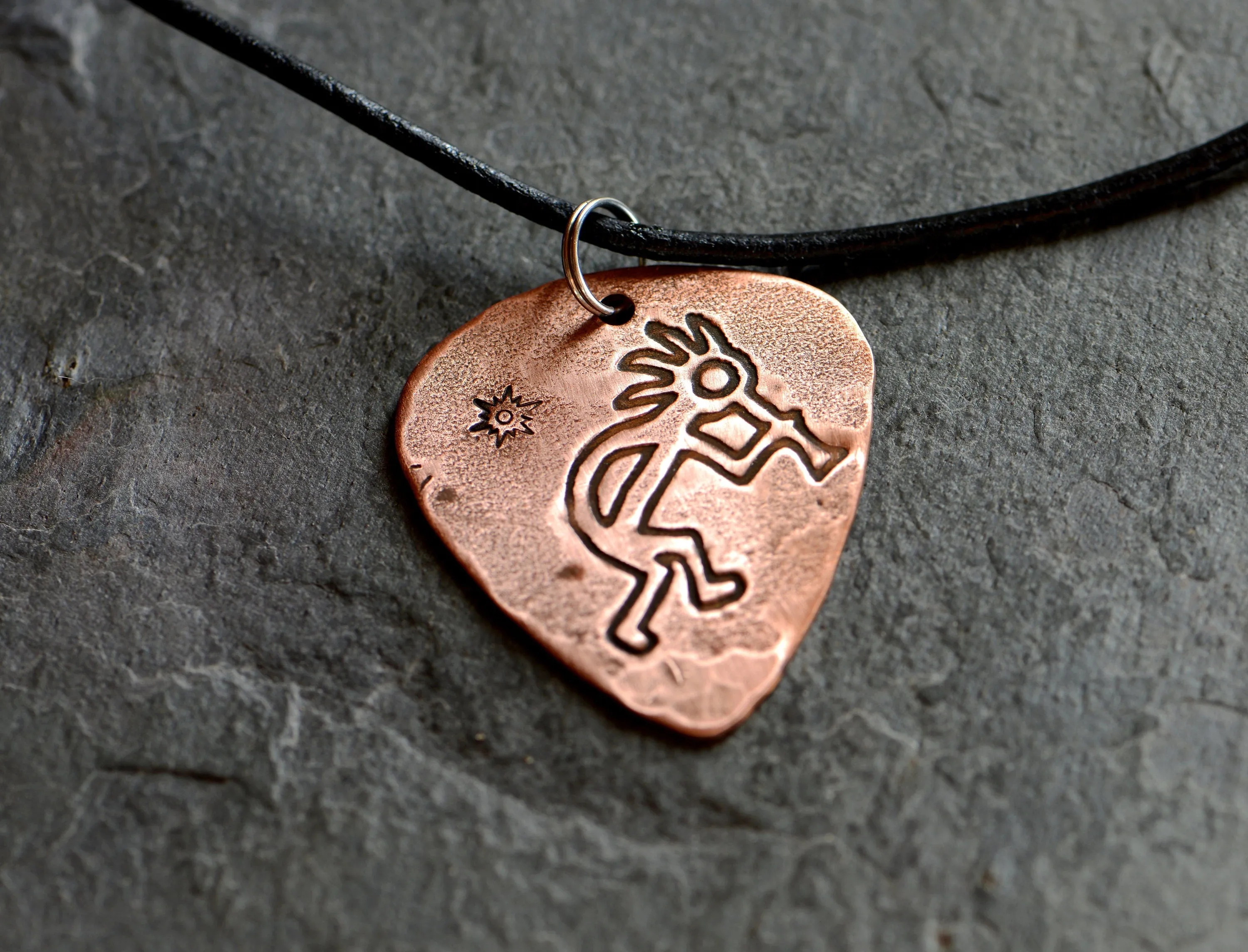 Kokopelli themed copper guitar pick necklace