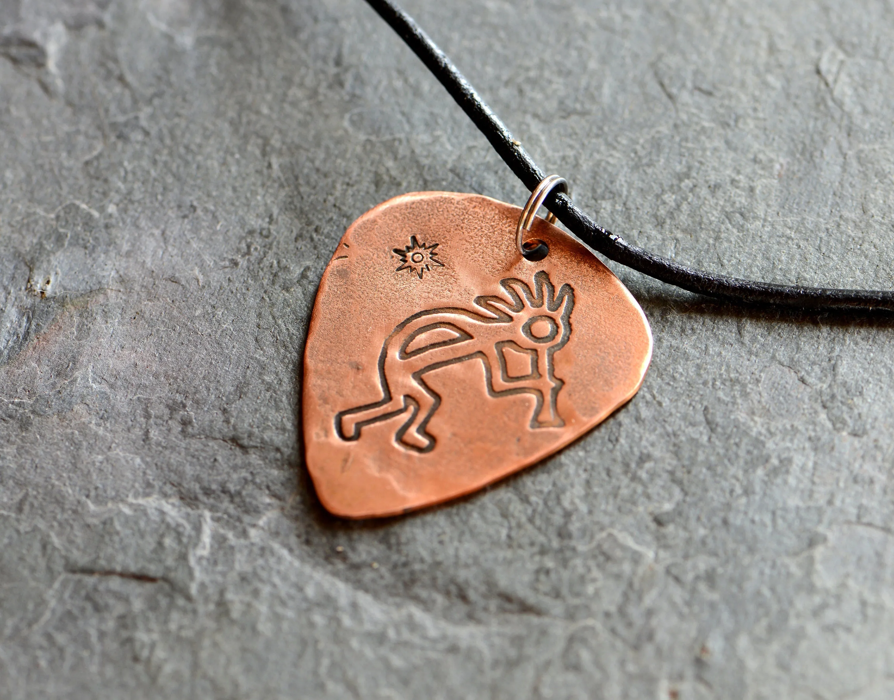 Kokopelli themed copper guitar pick necklace