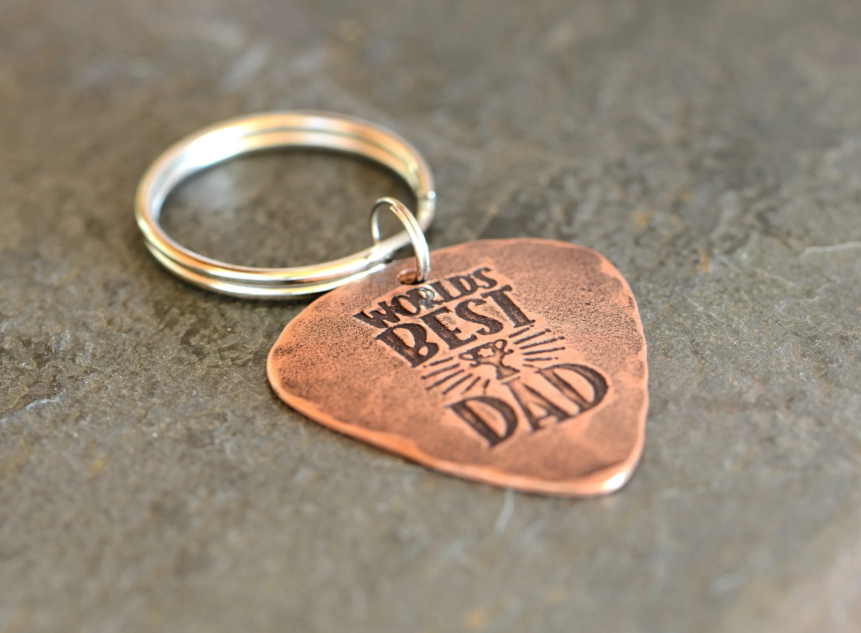 Worlds best dad stamped on a copper guitar pick keychain
